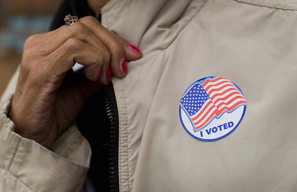 A voter shows off her "I Voted" sticker as she leaves a polling place on Nov. 4, 2014, in Ferguson, Missouri.
