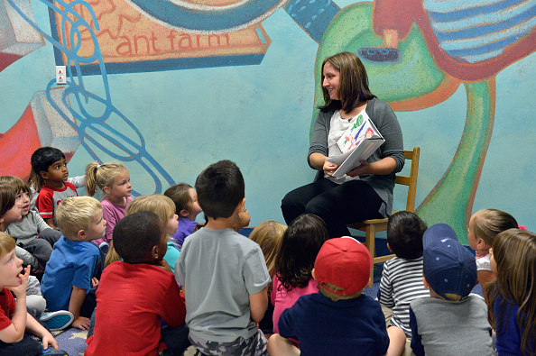 KinderCare Pre-School teacher Kimberly Bouchie reads to her students prior to being presented with the Knowledge Universe Early Childhood Educator Award.