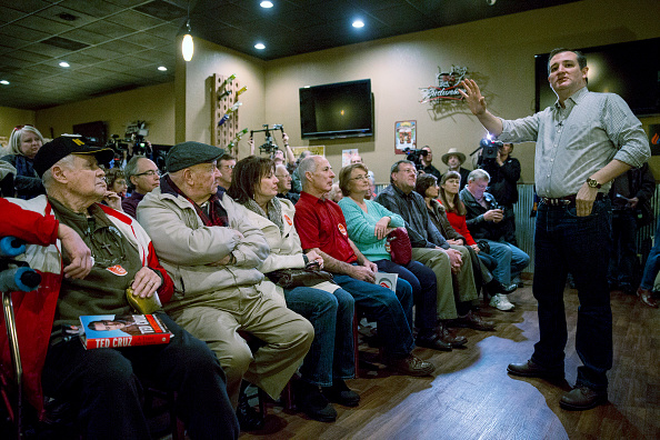 The campaign in Iowa heats up: Republican Ted Cruz, right, speaks at Charlie's Steakhouse, in Carroll, on Monday at the start of a six-day tour of the state.