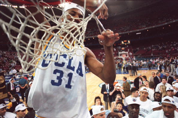 Then-UCLA forward Ed O'Bannon cuts down the net after his team's 89-78 victory over Arkansas for the NCAA title on April 3, 1995. Later, O'Bannon sued the NCAA for profiting from his image after his graduation without compensation.