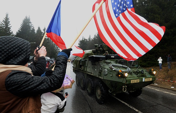 People greet US military convoys on the Czech- Polish border near Harrachov village on their way from Baltic countries to base in Vilseck, southern Germany in March 2015.  As a signal to Russia, the U.S. plans to quadruple military spending in Europe, particularly in the central and eastern regions.