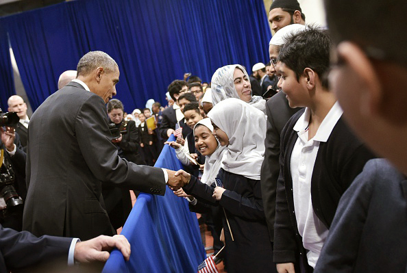 U.S. President Barack Obama greets attendees in an overflow room after speaking at the Islamic Society of Baltimore on February 3.