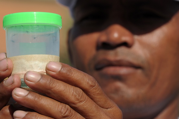 A Cambodian health official shows a bottle containing mosquitoes caught for testing in efforts to stem any outbreak of the Zika virus in Phnom Penh on Thursday.