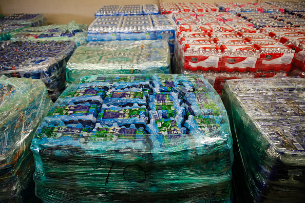Cases of bottled water are shown at a fire station on February 7 in Flint, Michigan. Months ago the city told citizens they could use tap water if they boiled it first, but now say it must be filtered to remove lead.