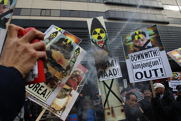 South Korean police extinguish flames after protesters burned an effigy of a North Korean leader Kim Jong-Un and a North Korean flag during an anti-North Korea rally on February 11 in Seoul, South Korea. South Korea announced on February 10 that the country would close an industrial complex jointly ran with North Korea, as the strongest response for North's recent nuclear test and rocket launch.
