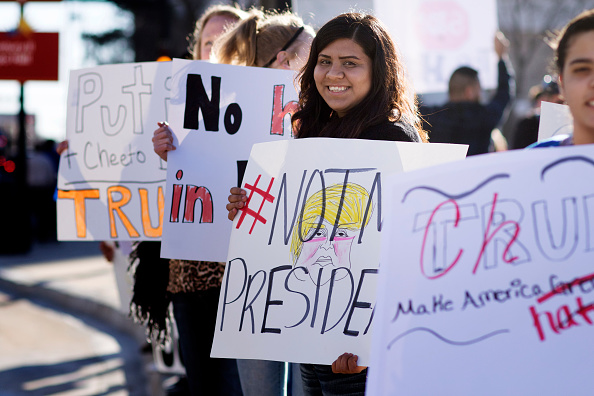 An anti-Trump protester stands outside the convention center where Republican presidential candidate Donald Trump made a speech at a campaign rally on March 5 in Wichita, Kansas. About 100 protesters voiced their opposition to Trump.