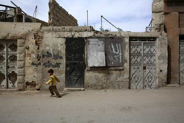 A Syrian boy walks in the al-Qaboun rebel-held northeastern suburb of the capital Damascus on March 13, 2016. One in three Syrian children have known nothing but a lifetime of war, UNICEF said, as the country's conflict enters its sixth year this week.