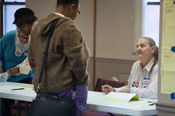 An election worker checks in a voter during Missouri primary voting at the First Baptist Church of Ferguson on March 15 in Ferguson, Missouri.
