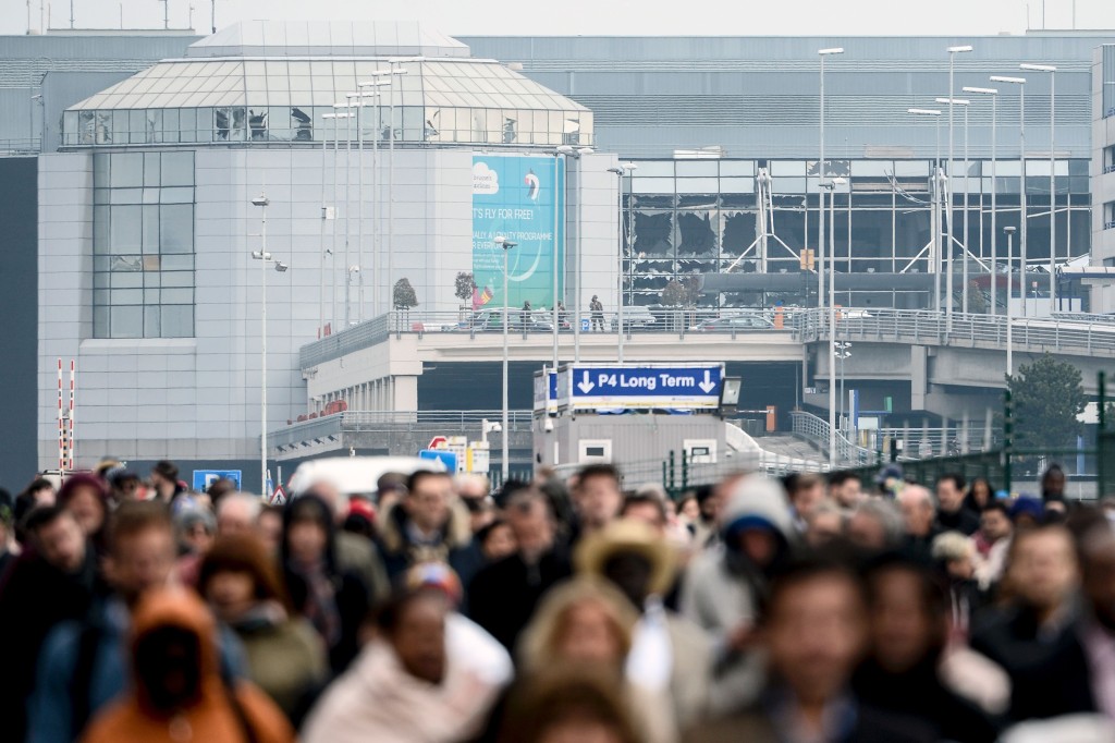 Passengers evacuate the Brussels Airport, in Zaventem, on March 22, after a string of explosions rocked Brussels airport and a city metro station, killing at least 26 people in apparently coordinated attacks, officials said.