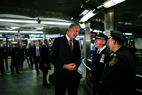 New York Mayor Bill de Blasio speaks with police officers on guard in the Times Square subway station in New York, March 22, as security measures have been tightened following the series of bombings in Brussels, Belgium.