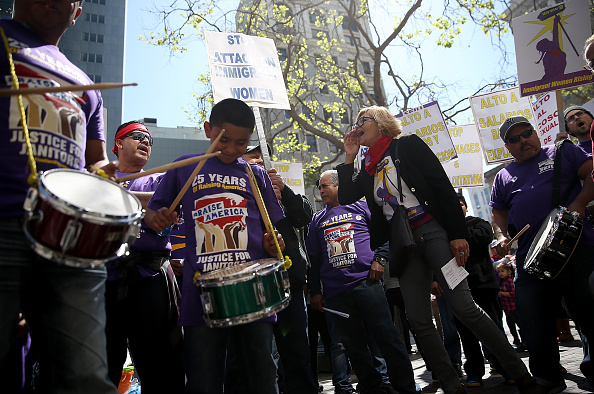 Union and fast food workers play drums during a demonstration in support of a proposal to raise the California minimum wage to $15 by 2022 on March 31 in Oakland, California. The proposal has since been signed into law by Governor Jerry Brown.