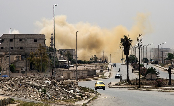 Smoke is seeing rising on a main road in the Salihin neighbourhood of Syria's northern city of Aleppo following a reported air strike on April 24.