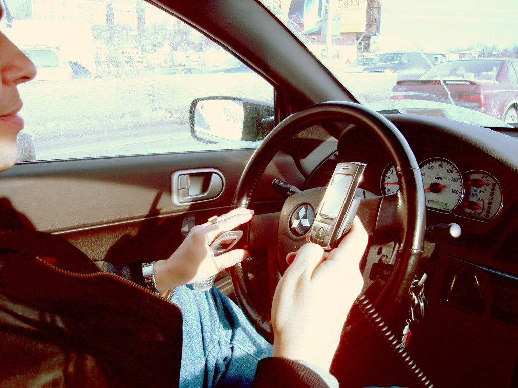 A driver in New York uses two mobile phones at once.