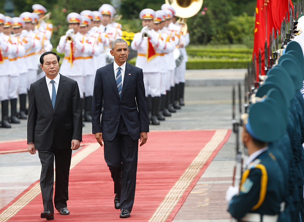 U.S. President Barack Obama (C) walks with his Vietnamese counterpart Tran Dai Quang (L) as they review a guard of honour during a welcoming ceremony at the Presidential Palace in Hanoi on May 23.