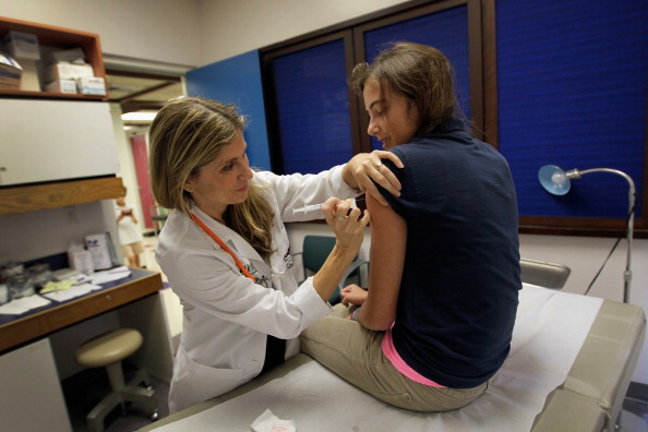 University of Miami pediatrician Judith L. Schaechter, M.D. (L) gives an HPV vaccination to a 13-year-old girl in her office at the Miller School of Medicine on September 21, 2011 in Miami, Florida.