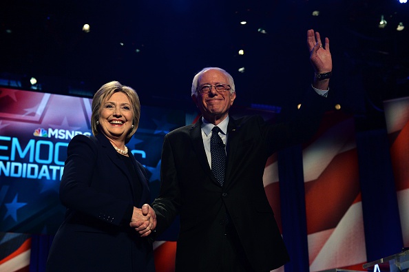 Democratic presidential candidates Hillary Clinton and Bernie Sanders shake hands before a presidential debate in Durham, New Hampshire on February 4.