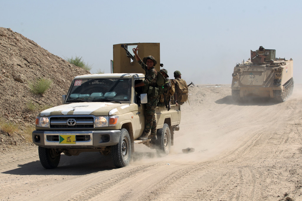 Iraqi government forces advance down a street June 2 in the Saqlawiyah area, north west of Fallujah, during an operation to regain control of the area from the Islamic State group. 