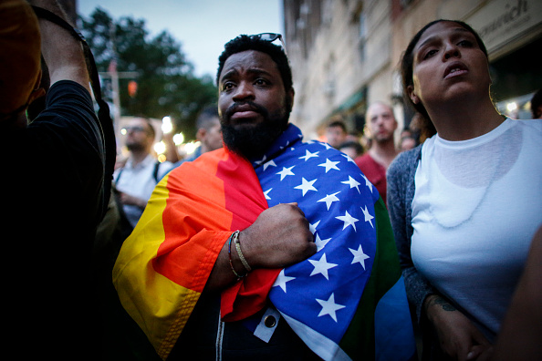 A man holds a flag during a vigil June 13 in solidarity for the victims killed at Pulse nightclub in Orlando in New York on June 13, 2016. 
