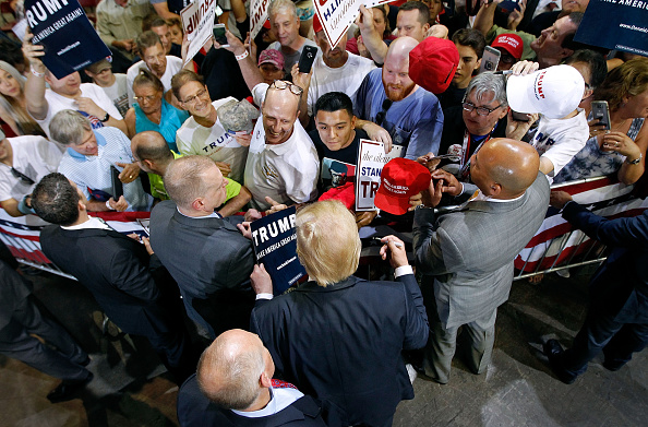 Republican presidential candidate Donald Trump (C) greets supporters following a campaign rally on June 18 in Phoenix, Arizona.