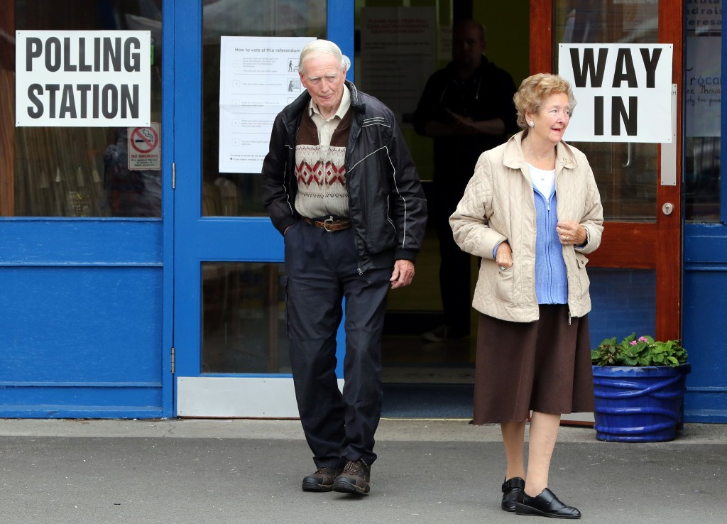 People leave a polling station in Belfast, Northern Ireland, on June 23 as the United Kingdom holds a referendum to vote on whether to remain in, or to leave the European Union.