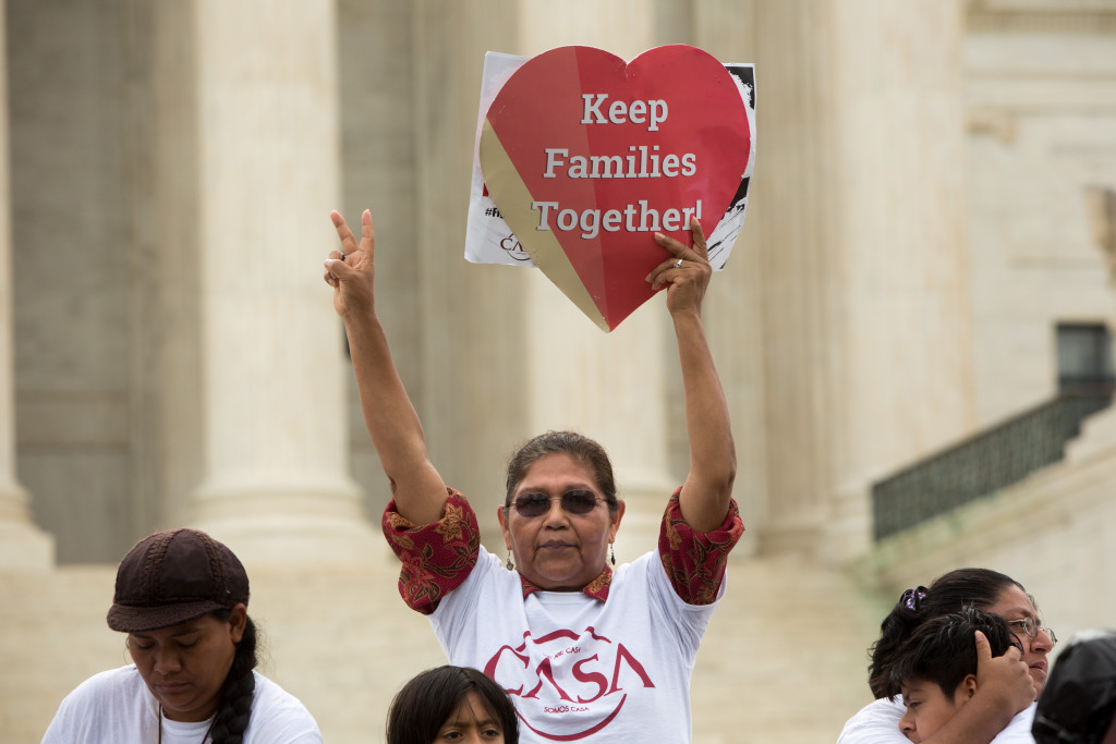 Antonia Surco, originally from Peru, holds a sign in front of the U.S. Supreme Court on a day where two important decisions on immigration and affirmative action were handed down by the court, on June 23 in Washington, DC.  The court was divided 4-4, leaving in place an appeals court ruling blocking Obama's immigration plan, which would have protected millions of immigrants from deportation.