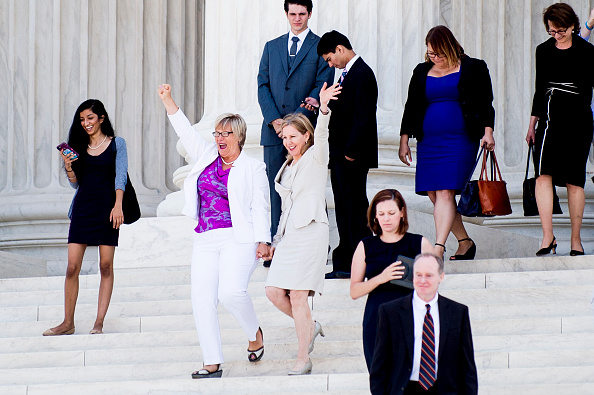 Texas abortion provider Amy Hagstrom-Miller and Nancy Northup, President of The Center for Reproductive Rights wave to supporters as they descend the steps of the United States Supreme Court on June 27 in Washington, DC.