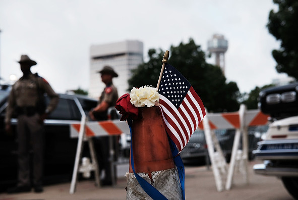 An American flag sits by the scene of Thursday evening's shooting in downtown Dallas on July 11.