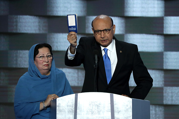 Khizr Khan, father of deceased U.S. soldier Humayun S. M. Khan, holds up a booklet of the U.S. Constitution as he delivers remarks at the Democratic National Convention on July 28 in Philadelphia, Pennsylvania. Standing next to him is his wife, Ghazala Khan.