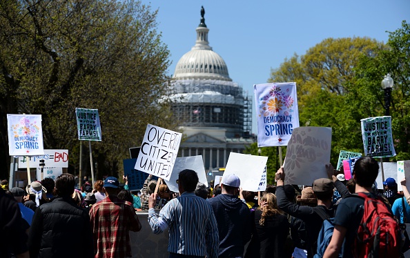 Protesters march to the Capitol building during a Democracy Spring demonstration in Washington, DC on April 13 calling to change voting laws and campaign finance.