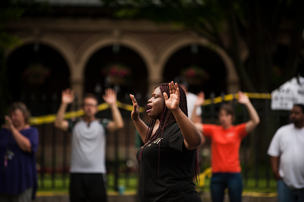 Minneapolis NAACP president Nekima Levy-Pounds leads a chant of 'Hands up, don't shoot,' for Philando Castile outside Governor's Mansion on July 7 in St. Paul, Minnesota. Castile was shot and killed July 6 by a police officer in Falcon Heights, MN.