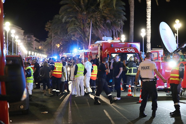 Police officers, firefighters and rescue workers are seen at the site of an attack on July 15 in Nice, France, that killed at least 60, in which a truck drove into a crowd watching a Bastille Day fireworks display.