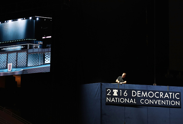 A worker puts up a sign as he helps set up the arena for the Democratic National Convention at the Wells Fargo Center on July 24 in Philadelphia, Pennsylvania.