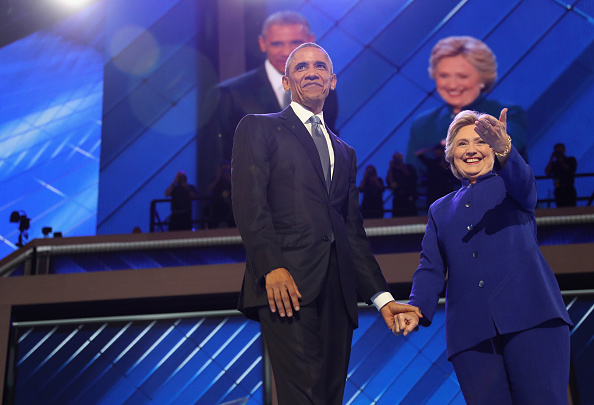 U.S. President Barack Obama and Democratic presidential nominee Hillary Clinton acknowledge the crowd on the third day of the Democratic National Convention at the Wells Fargo Center, July 27 in Philadelphia, Pennsylvania.