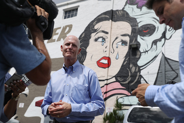 Florida Governor Rick Scott speaks to the media as he visits the Wynwood neighborhood where the Zika virus has broken out on August 4 in Miami, Florida. 