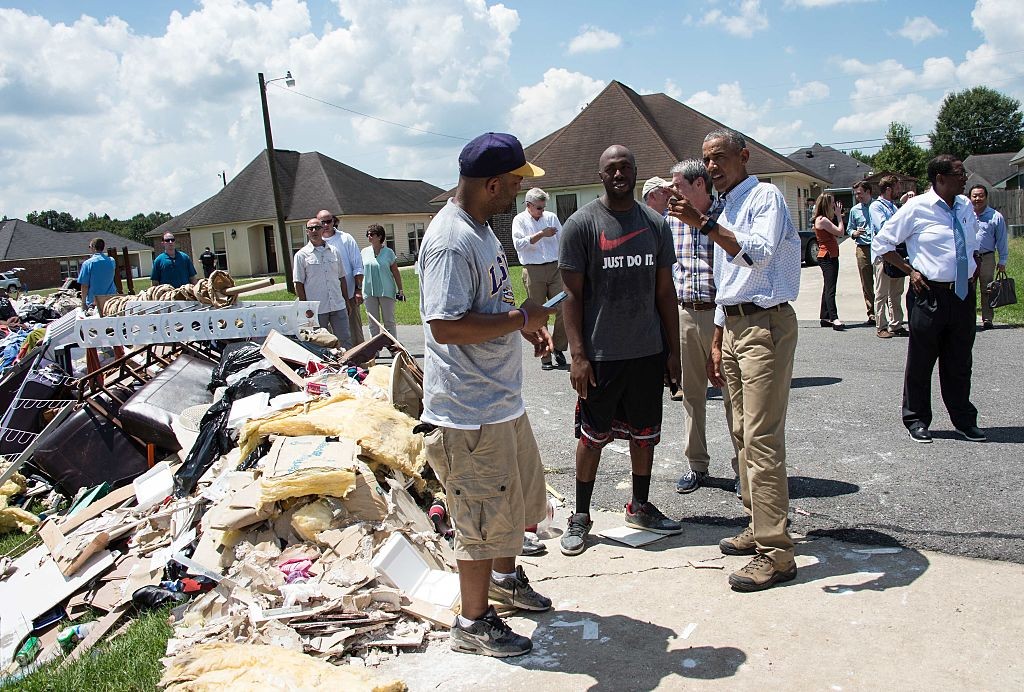 U.S. President Barack Obama speaks with residents as he tours a flood-affected area in Baton Rouge, Louisiana, on August 23.