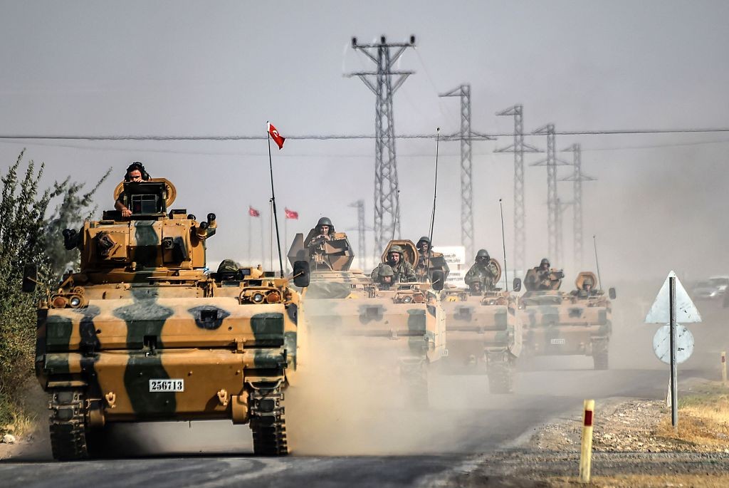 This picture taken on August 25 around 5 kilometers west from the Turkish-Syrian border city of Karkamis shows Turkish Army tanks driving to the town of Jarabulus.