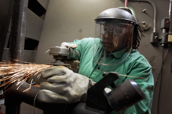 Caundra Ballard uses a grinder to prepare pipes for a weld as she continues her education as a pipefitter at the Air Conditioning, Refrigeration and Pipefitting Education Center in Opa Locka, Florida. 