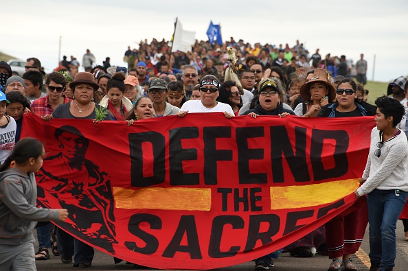 Native Americans march to a burial ground sacred site that was disturbed by bulldozers building the Dakota Access Pipeline (DAPL), near the encampment where hundreds of people have gathered to join the Standing Rock Sioux Tribe's protest of the oil pipeline that is slated to cross the Missouri River nearby, September 4 near Cannon Ball, North Dakota.