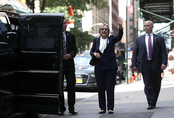 Democratic presidential nominee and former Secretary of State Hillary Clinton waves Sept. 11 as she leaves the home of her daughter Chelsea Clinton in New York City. Hillary Clinton left a Sept. 11 commemoration ceremony early after feeling overheated and went to her daughter's house to rest.  