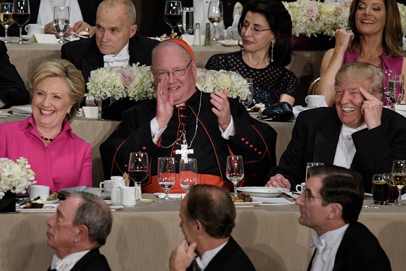 From left Democratic presidential nominee Hillary Clinton, Timothy Cardinal Dolan, Archbishop of New York, and Republican presidential nominee Donald Trump laugh during the Alfred E. Smith Memorial Foundation Dinner at Waldorf Astoria October 20, 2016 in New York, New York.     
