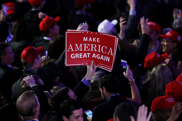 An attendee of Donald Trump's victory rally in New York City holds up a sign  that reads "Make America Great Again."   