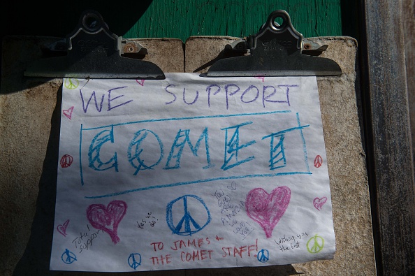 A sign is seen at the Comet Ping Pong restaurant in Washington, D.C., on December 5, 2016. An assault rifle-wielding gunman's appearance at the pizzeria, which was falsely reported to house a pedophile ring, has elevated worries over the unrelenting rise of fake news and malicious gossip on the internet. 
