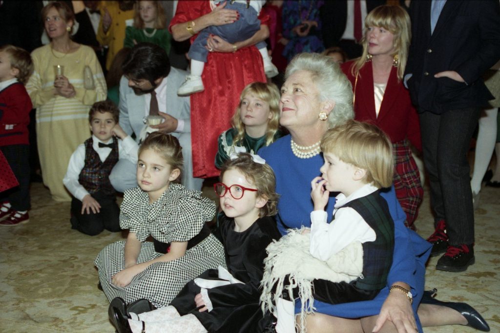 Mrs. Bush sits on the floor with her grandchildren and watches Frosty the Snowman, Residence of the White House,
December 17, 1989.