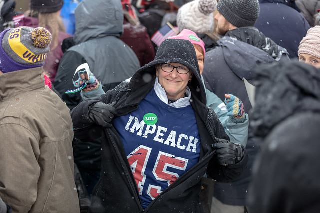 A woman wears a t-shirt showing her support for President Trump's impeachment at a rally for Democratic presidential candidate Amy Klobuchar. 