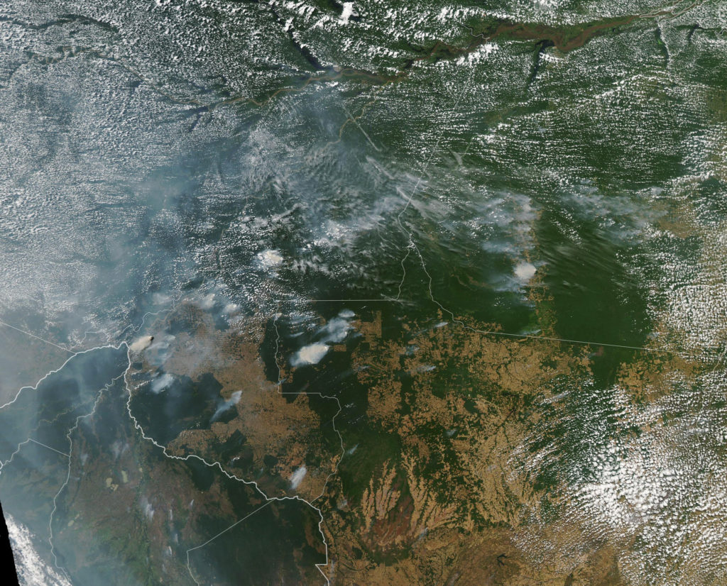 An image taken by a NASA satellite shows fires burning throughout the Amazon rainforest. 