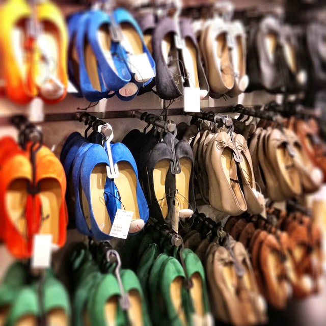 Rows of shoes at H&M. Author Dana Thomas says mass produced clothing like this is an environmental disaster.