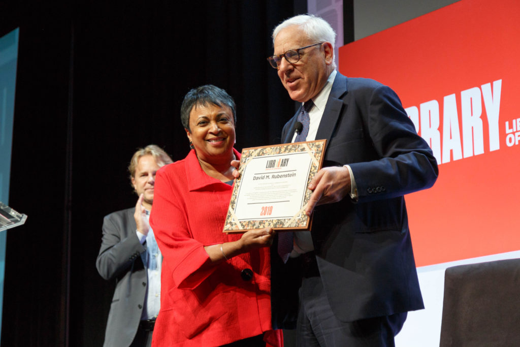 Librarian of Congress Carla Hayden presents National Book Festival sponsor David Rubenstein with a gift at the end of the festival, August 31, 2019. Photo by Shawn Miller/Library of Congress.

Note: Privacy and publicity rights for individuals depicted may apply.