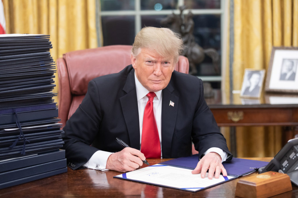 Pres. Donald Trump seated at his desk in the Oval Office in December 2018.
