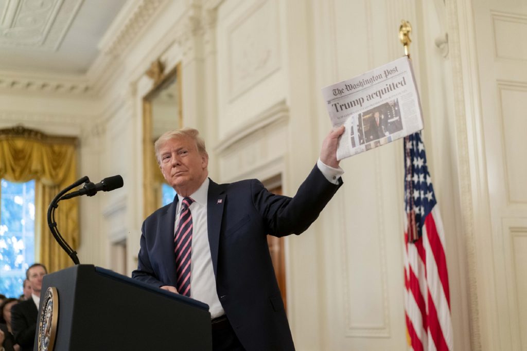 President Donald J. Trump shows a newspaper headline during his address Thursday, Feb. 6, 2020 in the East Room of the White House, after being acquitted in the U.S. Senate Impeachment Trial the previous day. 