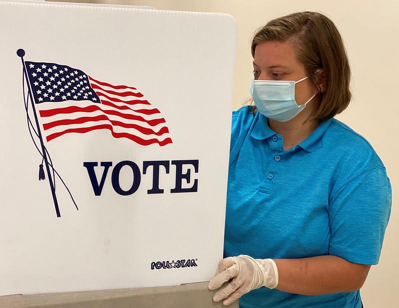 A ROTC Cadet sanitizes a voting station in Lawrenceburg, Ky., on June 12, 2020.